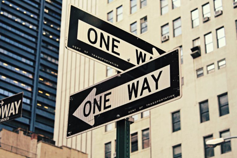 two one way street signs emphasizing the two options to choose an enrolled agent or a cpa