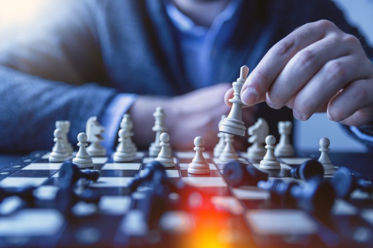 Man playing chess signifying strategy