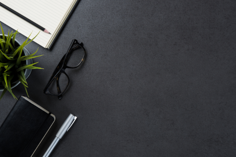 glasses, agenda, pencil and notepad in gray background with an overall business feel