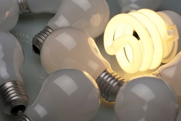 one lightbulb turned on among disconnected lightbubs